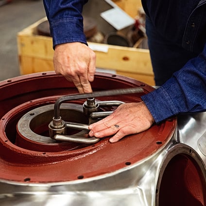 Separators employee tightening parts on a remanufactured centrifuge