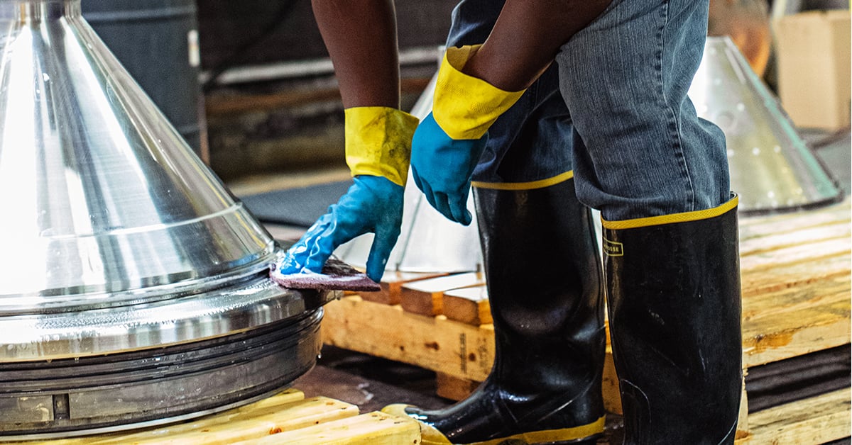 Man cleaning centrifuge.