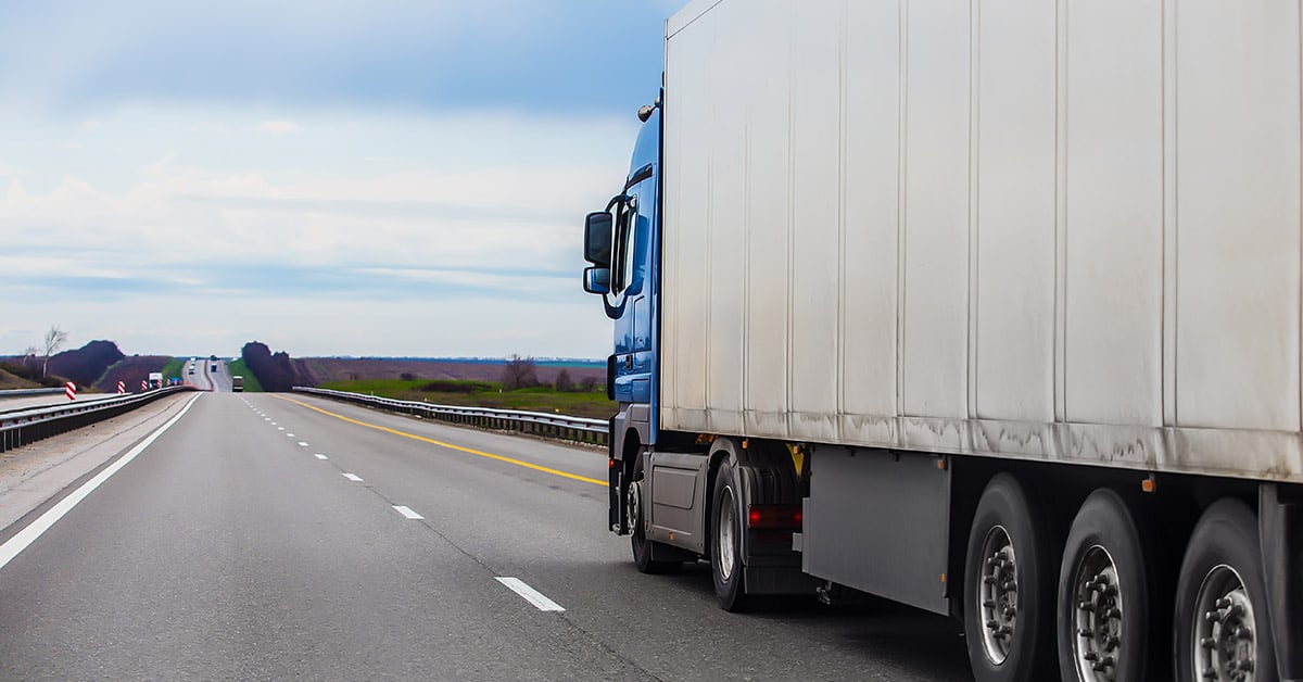 Freight truck drives down highway