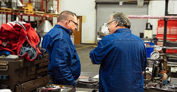 Separators shop techs work over equipment