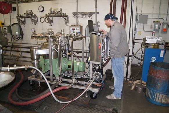 Image of a man working on a beer machine