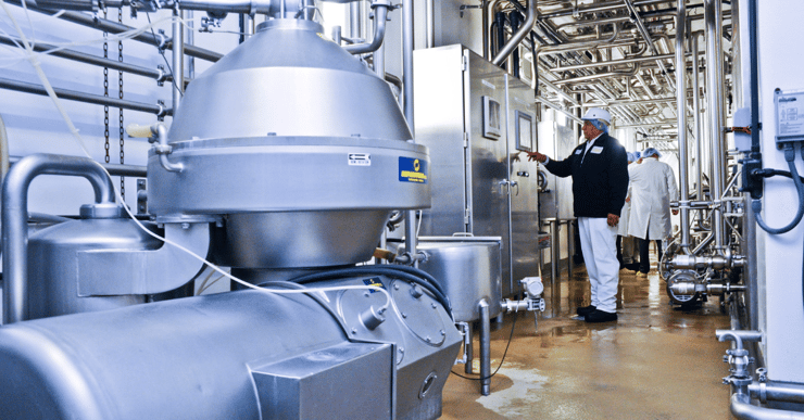 Image of a man pressing a button on equipment at a plant-1