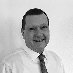 Image description: Black and white photo of Richard Schildwachter, Technical Service Manager at Separators, Inc. In a white button-down with a tie. 