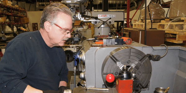 Image of a man working on a centrifuge part