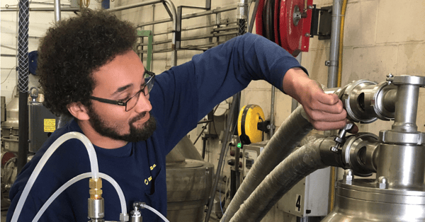 Image of a man working on a centrifuge