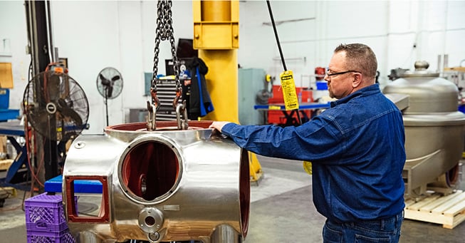 Separator employee works on centrifuge frame