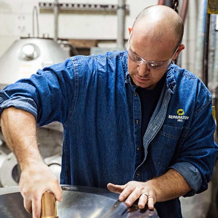 employee with centrifuge equipment