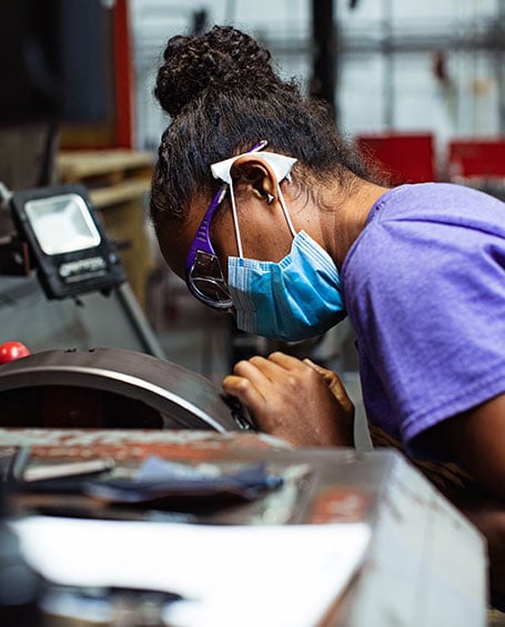 woman in shop working on centrifuge equipment