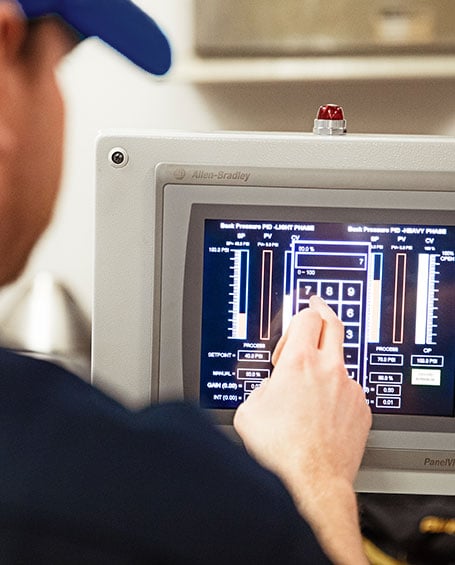 man working on control panel screen