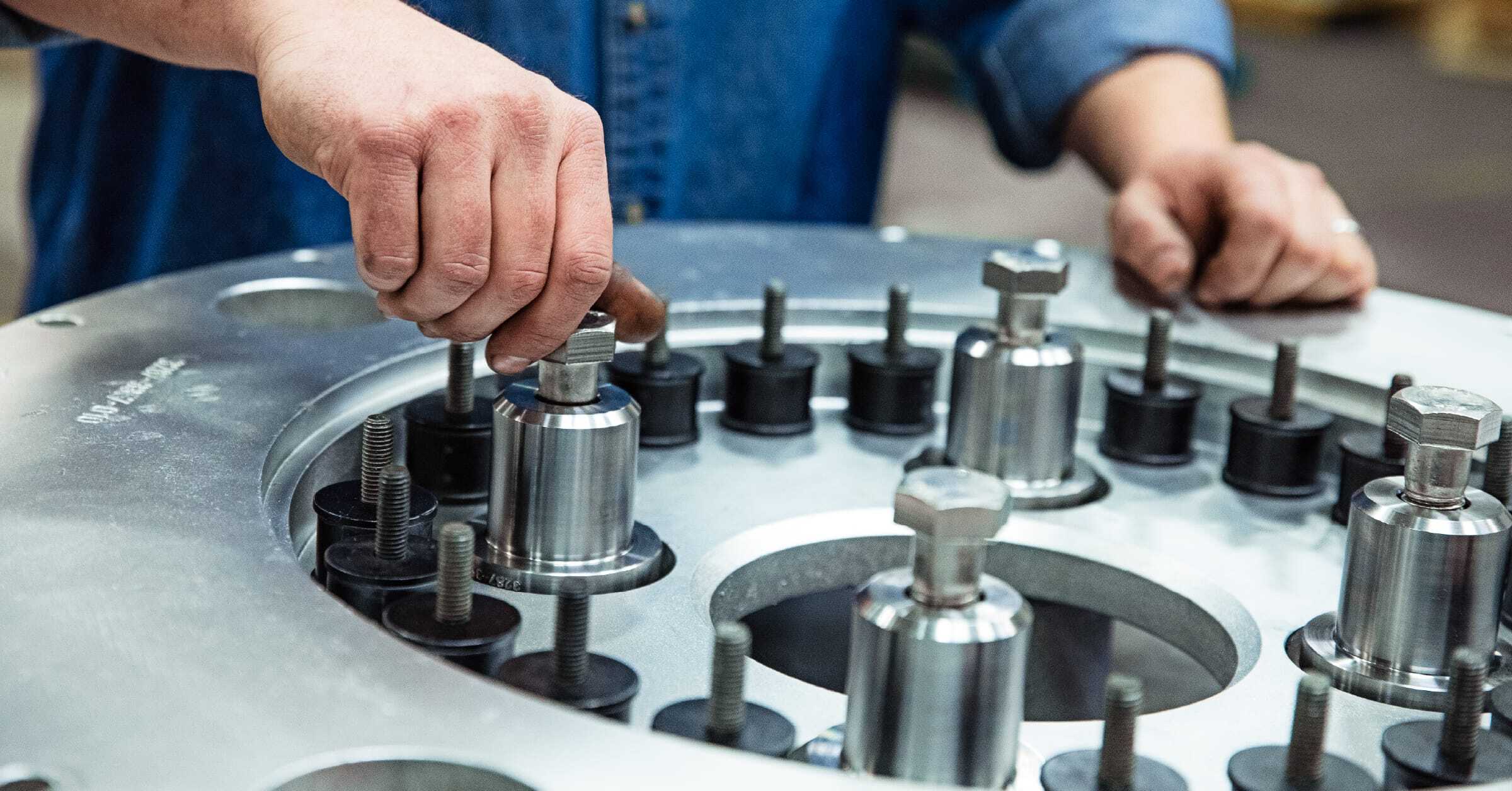 close-up-shot-of-man-adjusting-centrifuge-bolts
