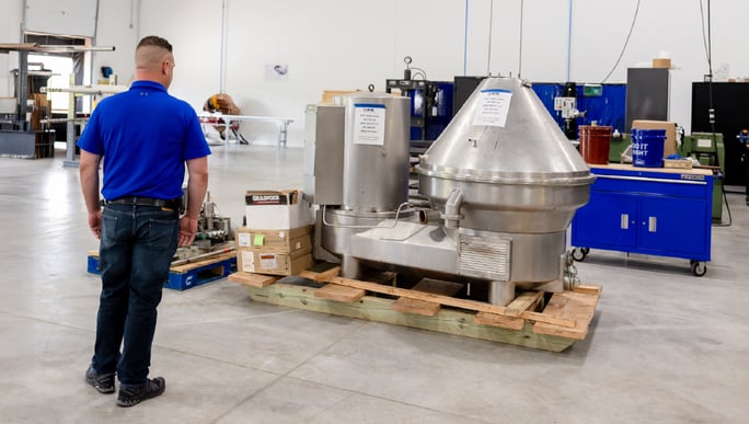Technician observing a centrifuge.
