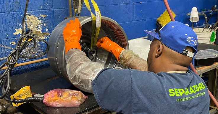 Technician cleaning a centrifuge.