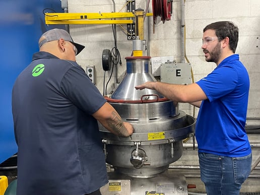 Centrifuge technician providing training.